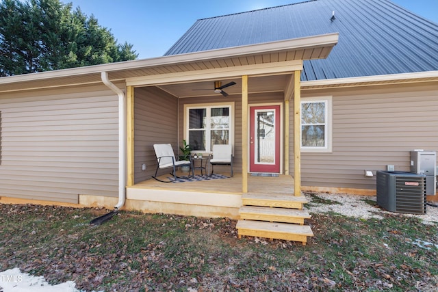 doorway to property featuring a wooden deck, central AC, and ceiling fan