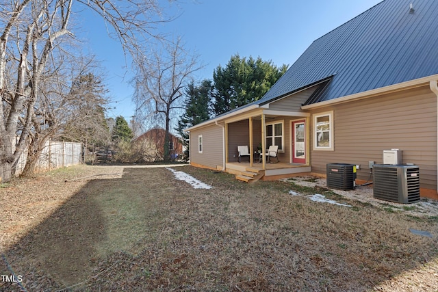 exterior space with a wooden deck, a yard, and central air condition unit