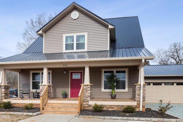 view of front of house featuring a porch and a garage