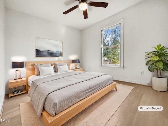 bedroom featuring light wood-type flooring and ceiling fan