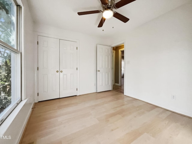 unfurnished bedroom featuring ceiling fan, a closet, and light hardwood / wood-style floors