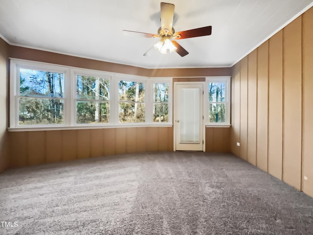 unfurnished sunroom with ceiling fan