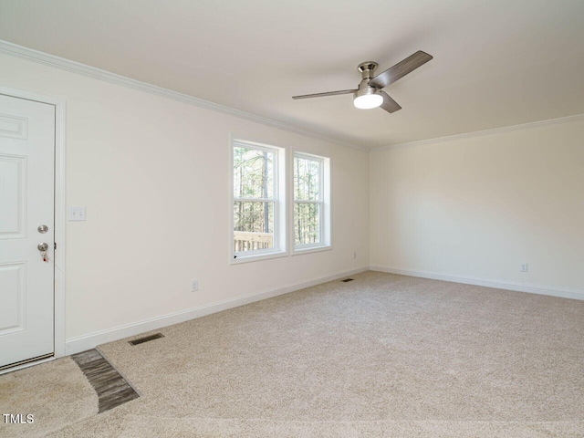 carpeted spare room with ornamental molding and ceiling fan