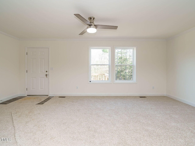 carpeted empty room featuring ceiling fan and ornamental molding