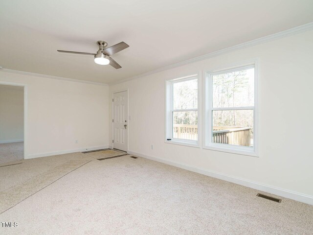 carpeted empty room with ornamental molding and ceiling fan