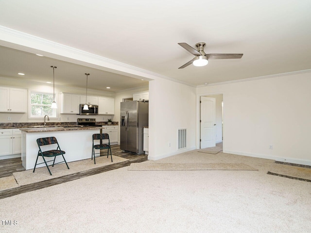 living room with ceiling fan, ornamental molding, sink, and light carpet