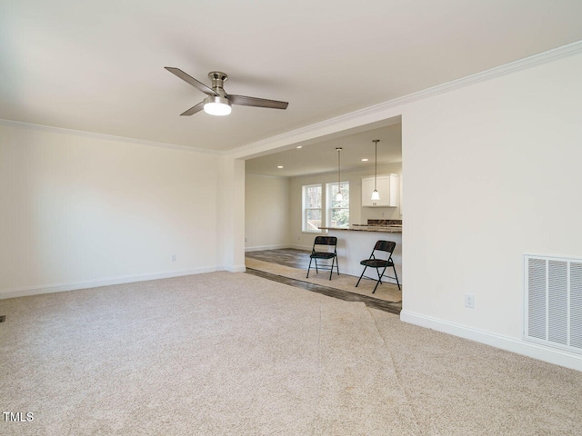 unfurnished living room featuring light carpet and ornamental molding