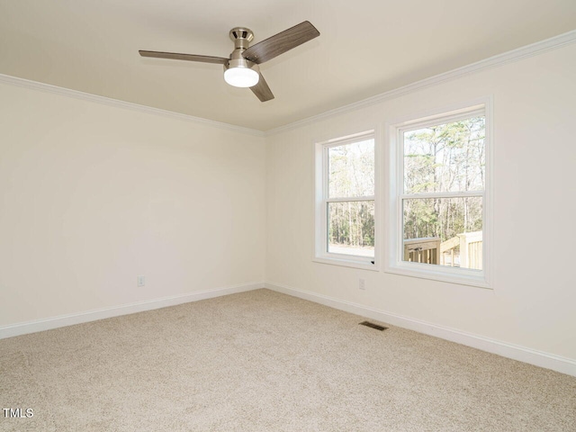 carpeted spare room with ornamental molding and ceiling fan