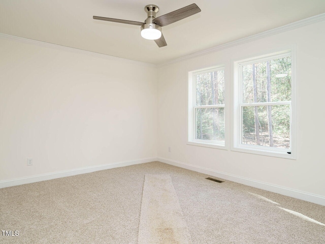 carpeted empty room with ornamental molding and ceiling fan