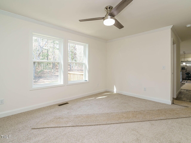 unfurnished room featuring crown molding, carpet flooring, and ceiling fan