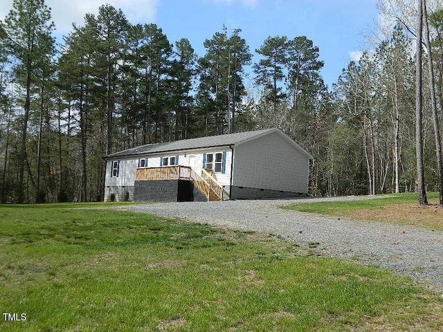 3050 Bennett Siler City Rd, Bennett, NC 27208 - manufactured / mobile home featuring driveway, a view of trees, a front lawn, and crawl space