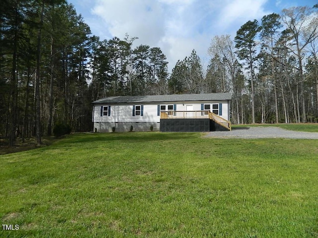 3050 Bennett Siler City Rd, Bennett, NC 27208 - manufactured / mobile home with a front yard, crawl space, stairway, and a wooden deck