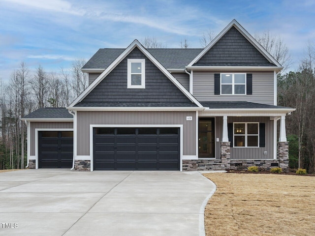 craftsman inspired home with stone siding, a porch, board and batten siding, concrete driveway, and an attached garage