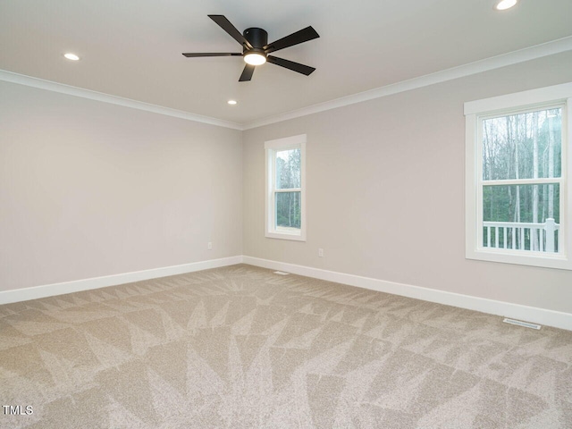 carpeted spare room with recessed lighting, visible vents, baseboards, and ornamental molding