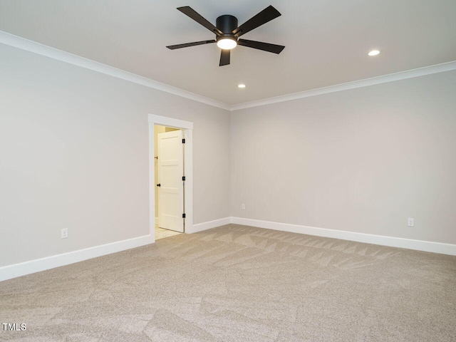 carpeted spare room with crown molding and ceiling fan