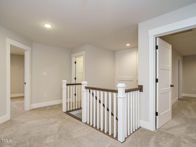 hallway featuring an upstairs landing, carpet flooring, recessed lighting, and baseboards