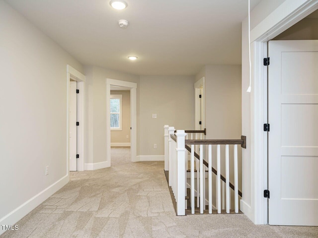 corridor featuring recessed lighting, baseboards, an upstairs landing, and carpet floors