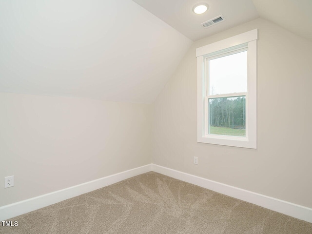 bonus room featuring visible vents, carpet flooring, baseboards, and vaulted ceiling