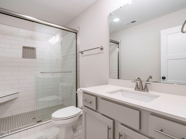 full bathroom featuring visible vents, a shower stall, toilet, and vanity