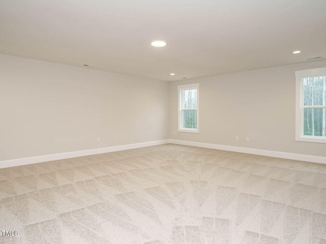 empty room with recessed lighting, baseboards, and light carpet