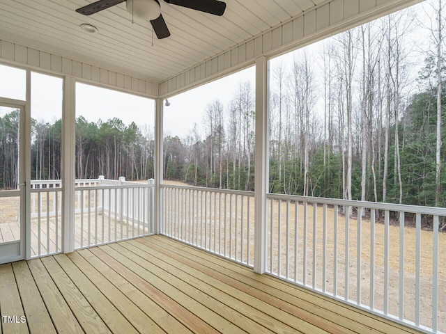 unfurnished sunroom featuring ceiling fan