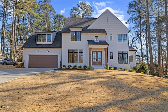 view of front facade with a garage and a front lawn