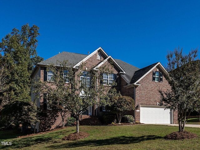 view of front of house with a garage and a front lawn