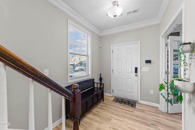 foyer entrance with crown molding and light hardwood / wood-style floors