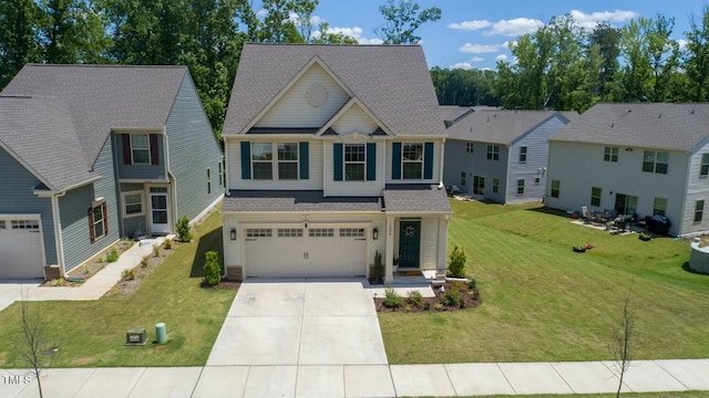 view of front of home with a front yard and a garage