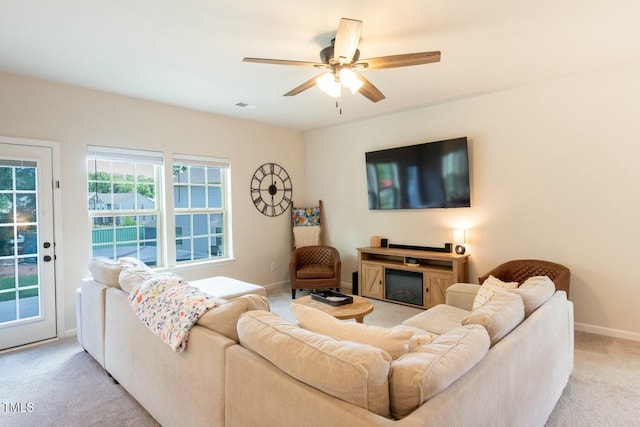 living room with ceiling fan and light colored carpet