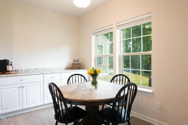 dining space featuring light wood-type flooring and a wealth of natural light