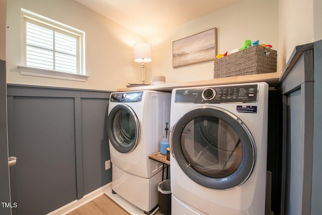 laundry room featuring light wood-type flooring and washing machine and clothes dryer