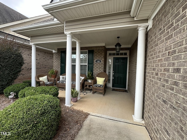 view of exterior entry with a porch