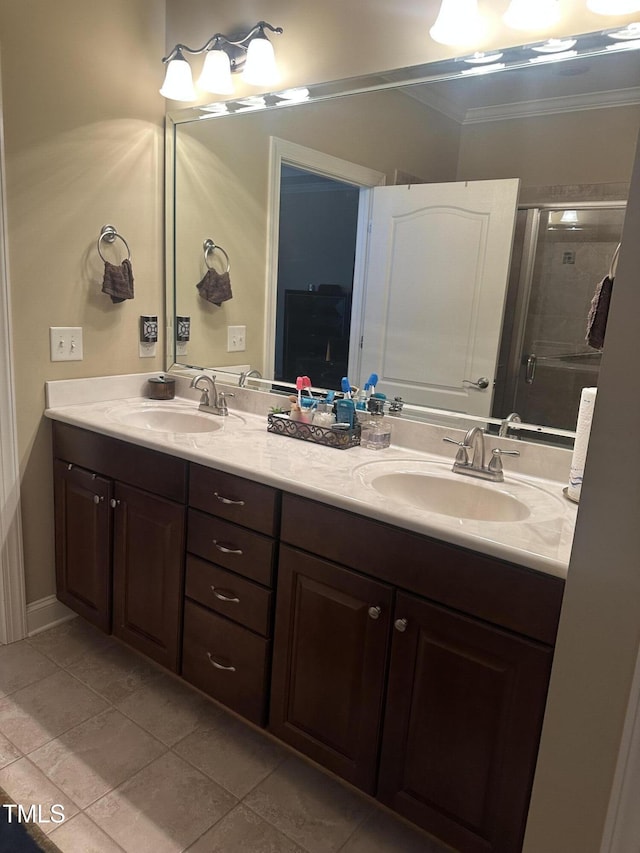 bathroom featuring ornamental molding, an enclosed shower, tile patterned floors, and vanity