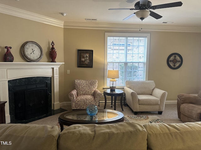 living room with ceiling fan, ornamental molding, and light carpet