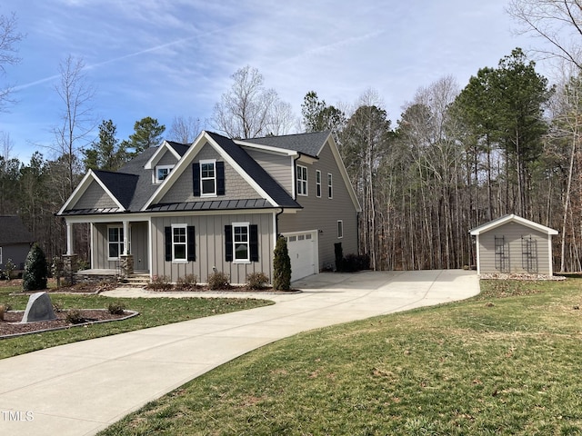 view of front of property with a garage, concrete driveway, board and batten siding, a standing seam roof, and a front yard