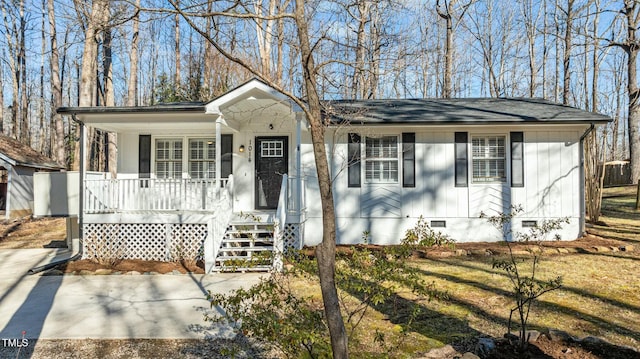 view of front of property with crawl space, a porch, and roof with shingles