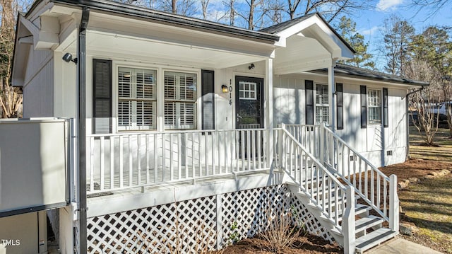 entrance to property with crawl space and a porch