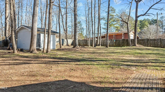 view of yard with an outdoor structure and a fenced backyard