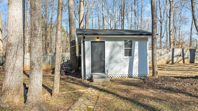 view of shed with central AC unit and a fenced backyard