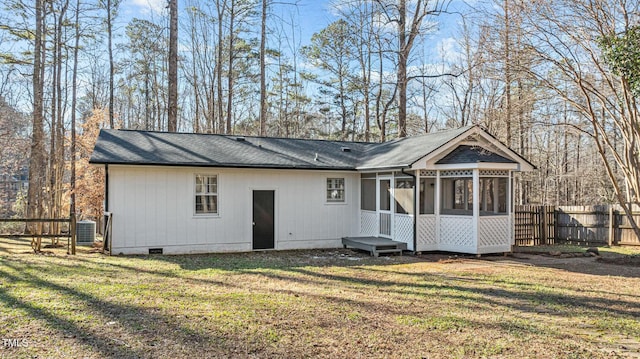 back of house featuring fence, central AC, a lawn, a sunroom, and crawl space