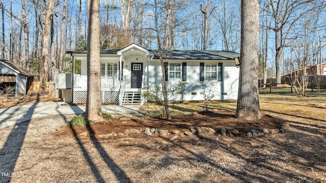 view of front of home with covered porch, driveway, and crawl space