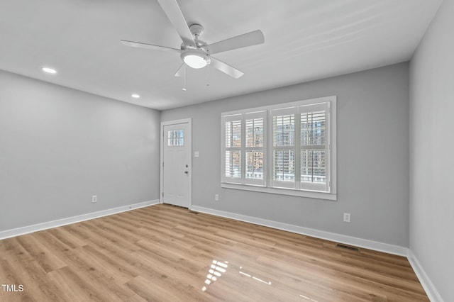 interior space with light wood finished floors, recessed lighting, a ceiling fan, and baseboards