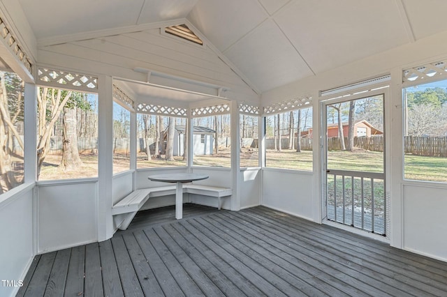 unfurnished sunroom with lofted ceiling