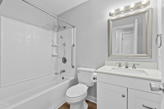 bathroom with baseboards, toilet, bathtub / shower combination, wood finished floors, and vanity