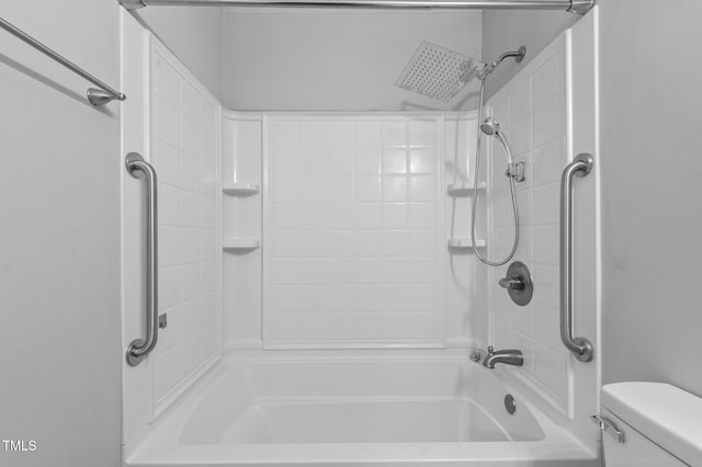 bathroom with bathtub / shower combination and toilet