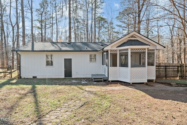 rear view of property with fence, a lawn, a sunroom, and crawl space