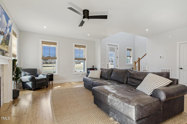 living room with ceiling fan and light hardwood / wood-style flooring