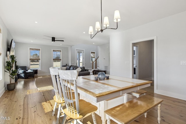 dining room featuring ceiling fan, a healthy amount of sunlight, and hardwood / wood-style floors