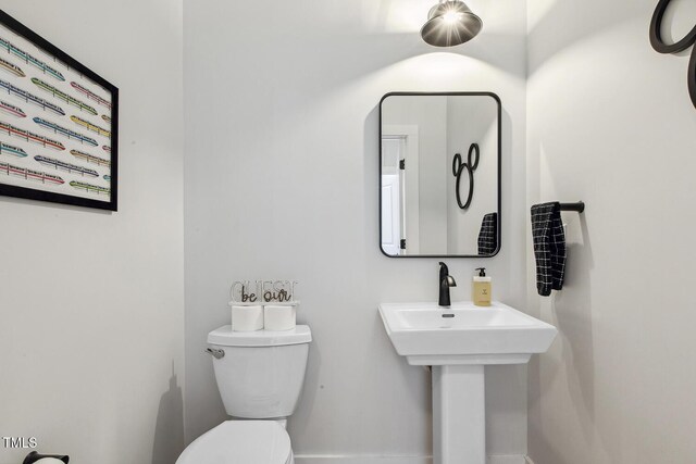 bathroom featuring sink and toilet